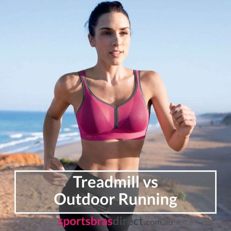 Woman running on a beach wearing a pink sports bra.