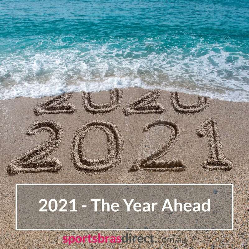 2021 written in the sand on a beach.