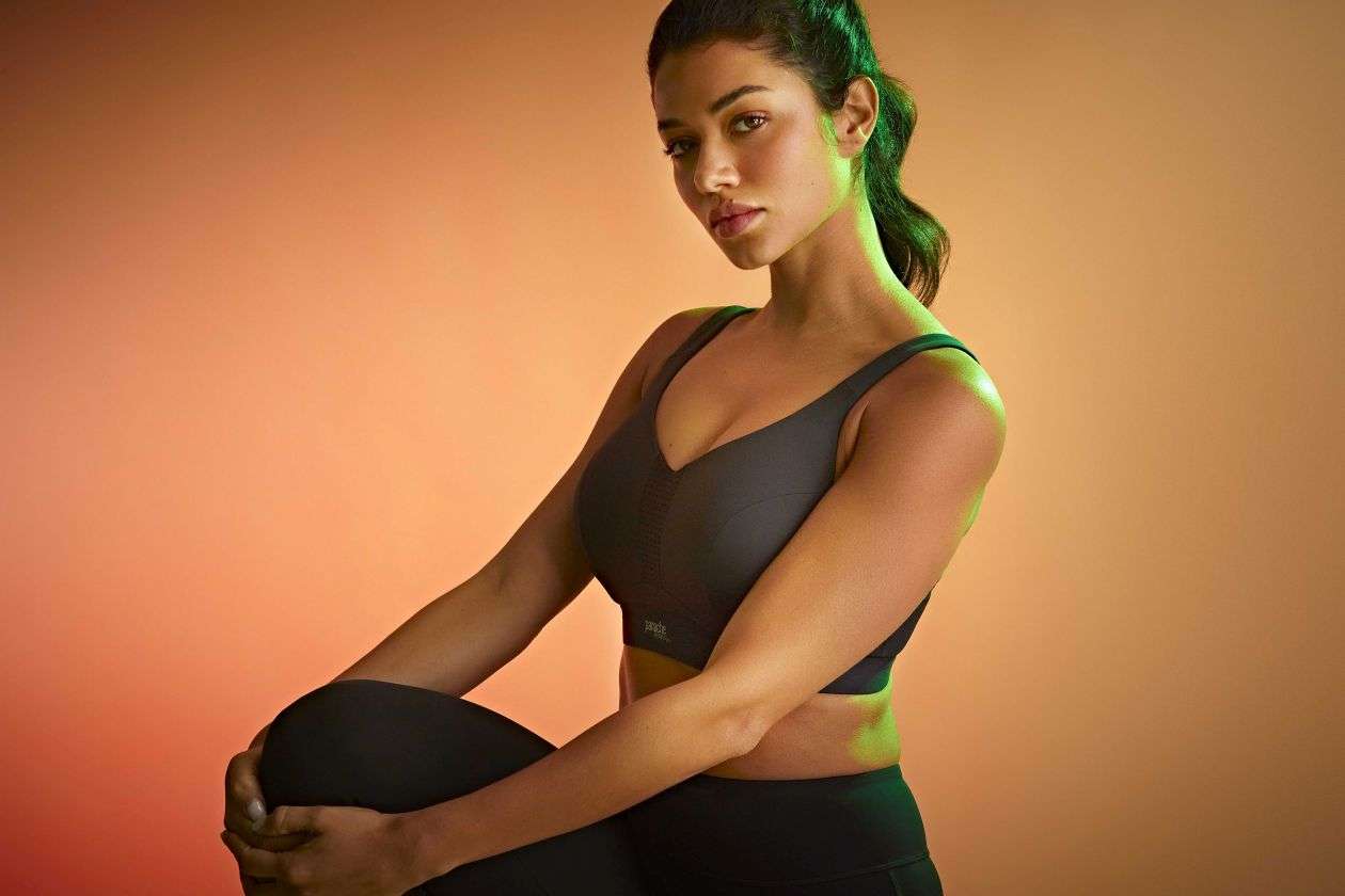 Woman sitting confidently in a sports bra.
