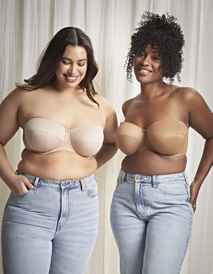 Two women wearing nude strapless bras with jeans, showing supportive full cup styles for fuller busts.