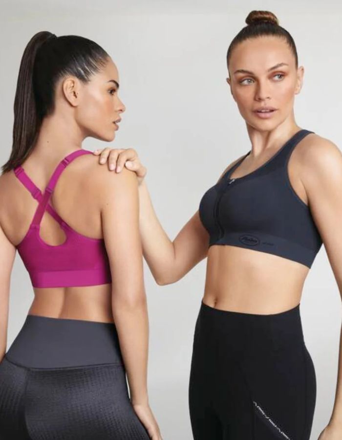 Two women modelling high-support sports bras, showing front and racerback designs for secure exercise support and comfort.
